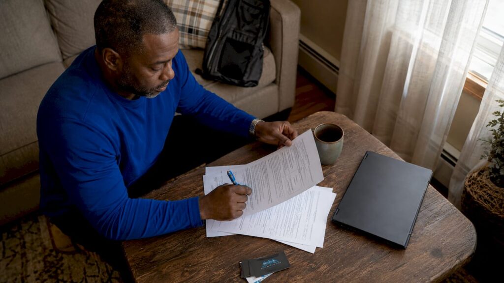 Contractor reviewing license documents at home table