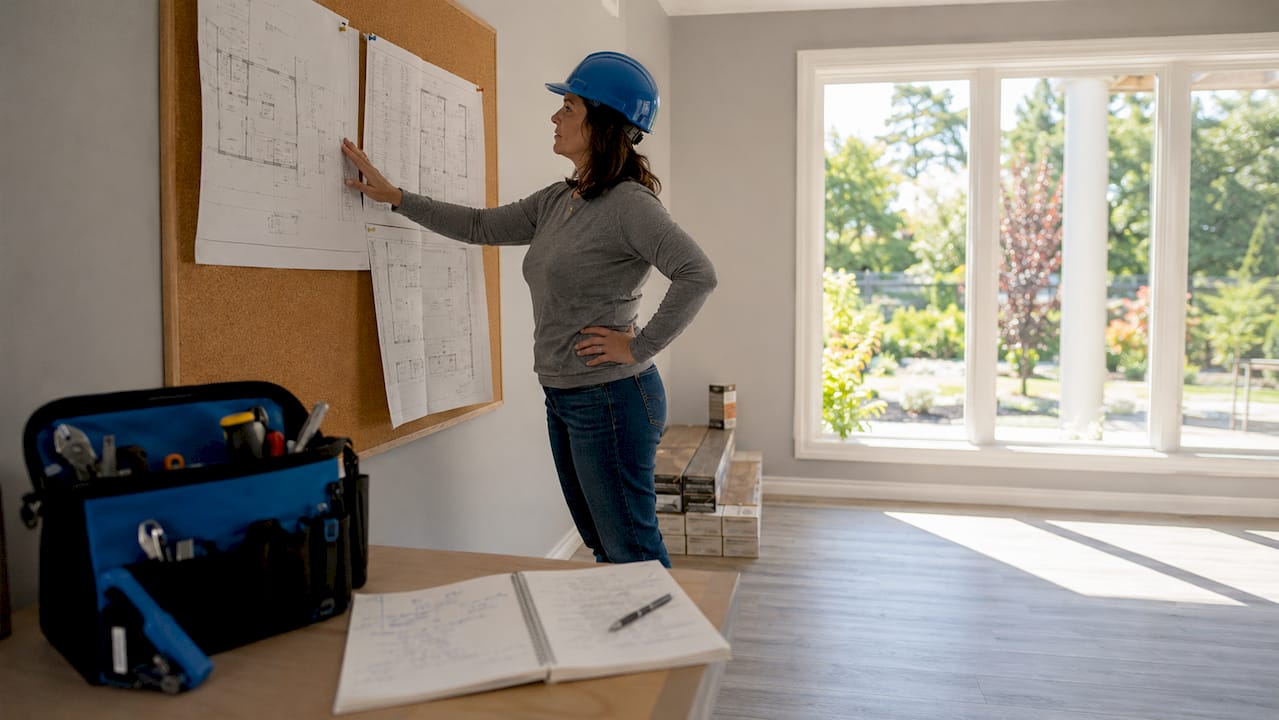 Renovation project manager reviewing plans in kitchen